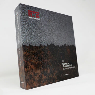 the front cover of the Surface Preparation & Coating Application Guide, made by HMG Paints, with an image of a rusted surface on the face of the guide